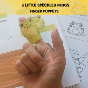 May include: A set of 5 Little Speckled Frogs finger puppets featuring printed paper illustrations of green frogs and a brown log. The sheets include colored frog characters and black and white line art outlines for coloring activities.