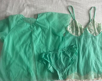 May include: Two sheer green nightgowns with lace trim. One nightgown has a button-up front and the other has a scoop neck.