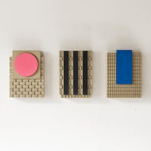 Concrete Brutalist Wall Sculptures, in warm concrete with Pink, Black and Blue.