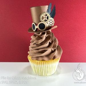 May include: A chocolate cupcake topped with brown frosting and a brown top hat with gold gears and black feathers. The cupcake is on a white surface.