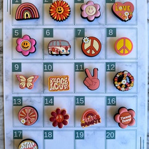 May include: A set of 20 colorful, retro-themed charms with various designs, including peace signs, flowers, butterflies, and rainbows. The charms are numbered 1 through 20 on a white background.