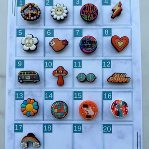 May include: A chart displaying 20 colourful, round, plastic shoe charms with various designs, including peace signs, flowers, hearts, mushrooms, and a bus. The chart is labelled with numbers 1 through 20.
