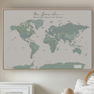 May include: A framed world map with the text "Your Names Here Adventures Around The World" hangs above a white nightstand and a wicker rocking chair. A woven basket and a stuffed animal are also in the room. The map is light grey and green.