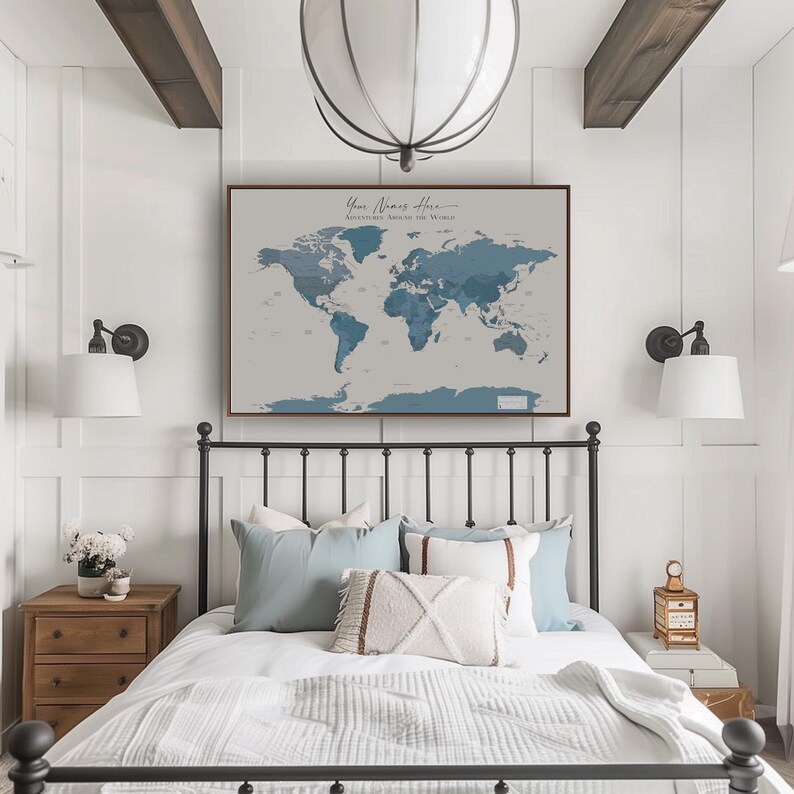 Framed calming world map in navy blue tones styled with natural textures and greenery; a perfect wanderlust map print for coastal homes and travel-inspired decor lovers.