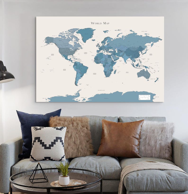Navy world map wall art displayed in a modern living room with coastal-inspired decor; calming dark blue tones create a minimalist and wanderlust aesthetic perfect for travelers.