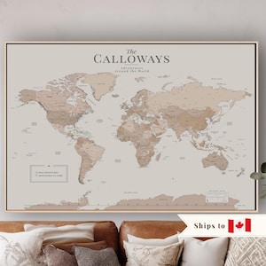 May include: A large rectangular world map wall art piece featuring a neutral beige background with continents rendered in shades of tan and brown. The text reads The CALLOWAYS Adventures Around the World, with a legend for Past Adventures and Adventures to Come.