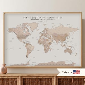 May include: A framed world map print in muted beige and brown tones featuring the text And this gospel of the kingdom shall be preached in all the world Matthew 24:14 at the top. The map displays continents and countries in a neutral palette.