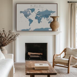 Digital printable navy world map pinned on a modern gallery wall; the calming blue tones and clean layout add a wanderlust vibe to any living room or office.