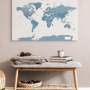 Close-up of a navy world map with minimalist design and soft wanderlust lettering; perfect for travel lovers who want a stylish and calming piece of wall decor.