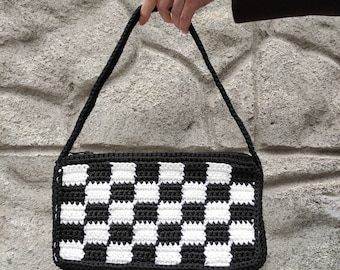 A popular bag made of "chess" pattern. The most relevant model of this season, which will complement both daily and evening images.