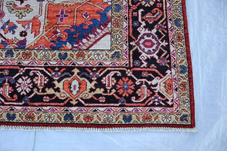 May include: A traditional Persian rug with a dark red, black, and cream color scheme. The rug features intricate floral and geometric patterns.