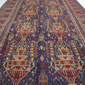 May include: A traditional Persian rug with a deep blue background and intricate floral patterns in shades of red, green, and yellow. The rug features a repeating design of stylised flowers and leaves.