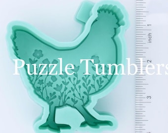May include: A light green silicone mold shaped like a chicken with a floral pattern. The mold is approximately 6 inches tall and 4 inches wide.