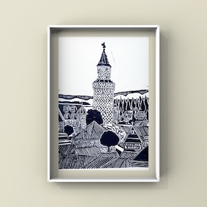 May include: A black and white woodcut print of a village with a tall tower in the centre. The print is framed in a white frame.