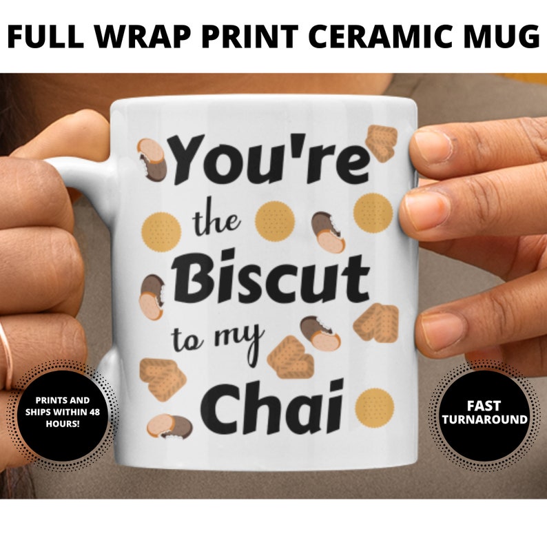 May include: White ceramic mug with the text "You're the Biscuit to my Chai" in black. The mug is decorated with illustrations of biscuits and cookies. The words "FULL WRAP PRINT CERAMIC MUG" are at the top.