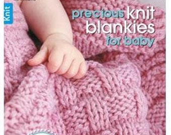 May include: A book titled "Precious Knit Blankies for Baby" with a pink knitted baby blanket on the cover. The book features 16 knit patterns for baby blankets designed by Jean Adel.