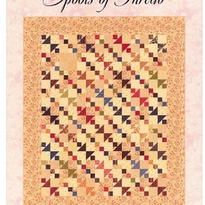 May include: A quilt pattern titled Buttons, Bobbins and Spools of Thread by Betsy Chutchian Designs. The quilt features a repeating geometric block design in various colours including red, blue, green, and cream, with a floral border. Size 138.4 cm x 168.9 cm.