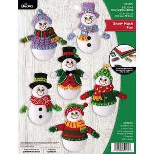 May include: A set of six felt snowman ornaments to be stitched with sequins and beads. The ornaments are 5 1/2 inches by 5 1/2 inches and come with instructions.