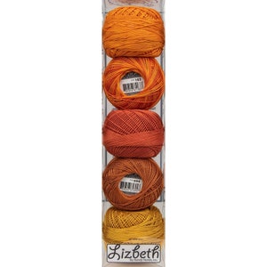 May include: A set of four balls of Lizbeth embroidery floss in shades of orange, red, and yellow. The balls are packaged in a clear plastic box with a label that reads "Lizbeth by Handy Hands, Inc."