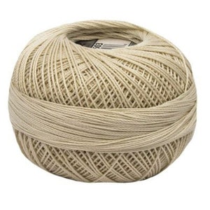 May include: A ball of beige yarn, ready for knitting or crocheting projects.