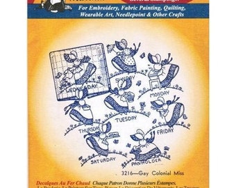 May include: A set of iron-on transfers featuring a whimsical design of mice dressed in dresses and holding signs with the days of the week. The transfers are labeled "Aunt Martha's Hot Iron Transfers" and "3216-Gay Colonial Miss".
