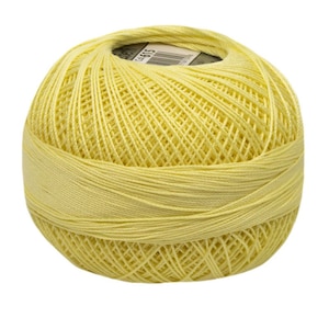 May include: A ball of pale yellow yarn. The yarn is wound into a ball shape and is ready for knitting or crocheting.