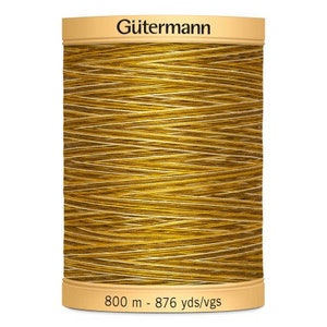 May include: A spool of Gütermann thread in a gold colour. The spool is labelled with the brand name and the length of the thread: 800 m - 876 yds/vgs.
