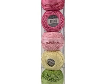 May include: A set of five balls of embroidery floss in a clear plastic container. The floss is arranged in a vertical stack, with the colours transitioning from pink to yellow to green. The brand name "Lizbeth" is printed on the bottom of the container.