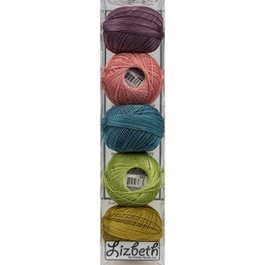 May include: A set of six balls of Lizbeth embroidery floss in a clear plastic container. The colours are purple, pink, teal, green, and yellow.