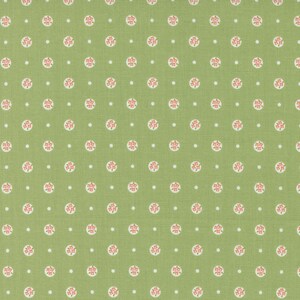 May include: A green fabric with a repeating pattern of small white dots and pink flower clusters in white circles.