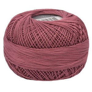 May include: A ball of deep pink yarn, ready for knitting or crocheting.