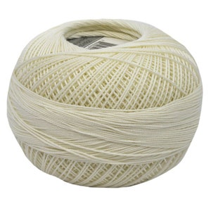 May include: A ball of off-white crochet thread, tightly wound into a spherical shape. The thread is smooth and appears to be cotton or a similar natural fiber. The thread is ideal for crochet and other crafts.