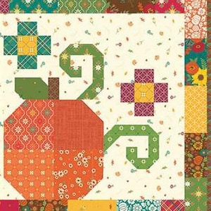 May include: A patchwork quilt featuring a large orange pumpkin with green vines and floral accents. The quilt has a cream background with small floral patterns and a colourful border with various geometric and floral designs.