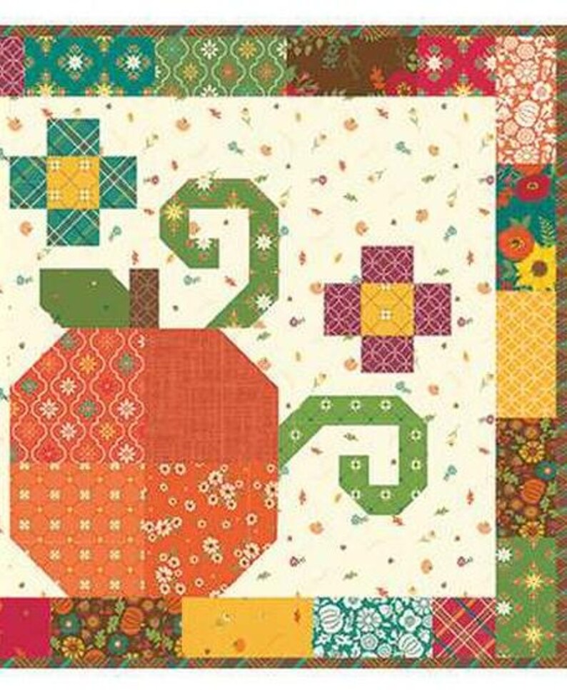 May include: A patchwork quilt featuring a large orange pumpkin with green vines and floral accents. The quilt has a cream background with small floral patterns and a colourful border with various geometric and floral designs.
