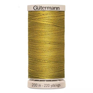 May include: A spool of Gütermann thread in a golden yellow color. The thread is tightly wound around a white spool with the brand name "Gütermann" printed on the top. The bottom of the spool has the text "200 m - 220 yds/vgs".