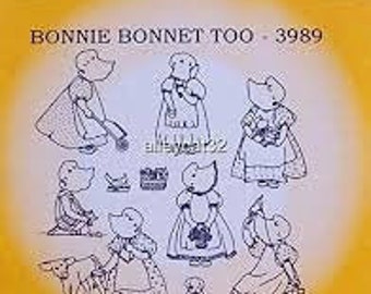 May include: A sheet of iron-on transfers featuring illustrations of a cartoon character wearing different outfits. The character is a small, anthropomorphic animal with a large head and a long snout. The text "Bonnie Bonnet Too - 3989" is printed at the top of the sheet.