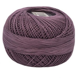 May include: A ball of purple yarn, ready for knitting or crocheting.