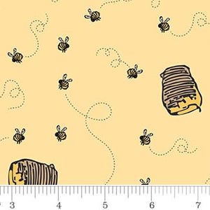 May include: Yellow fabric with a repeating pattern of cartoon bees and beehives. The bees are black and yellow, with dotted flight paths. The beehives are brown and yellow. The fabric has a ruler along the bottom, with measurements in inches.