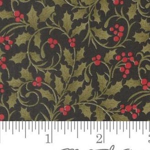 May include: A fabric featuring a repeating pattern of dark green holly leaves and bright red berries on a black background, positioned above a white ruler showing measurements in inches to indicate the scale of the printed design.