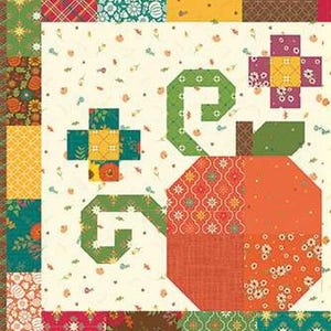 May include: A patchwork quilt block with a large, stylised pumpkin in shades of orange and red. The pumpkin has a green stem and vine. The background is cream-coloured with small floral patterns, and the border is a mix of patterned fabrics.
