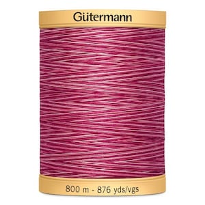 May include: A spool of Gütermann thread in a pink and white colourway. The spool is labelled with the brand name and the length of the thread: 800 m - 876 yds/vgs.