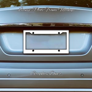 May include: A white license plate frame mockup with black screw covers is centered on the back of a silver car. The text "License Plate Frame Mockup" is arched above the frame, and "Graphics Diner" is below.