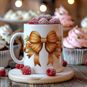 May include: White ceramic mug featuring a brown bow design. The mug is filled with red raspberries and is surrounded by cupcakes.