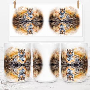 May include: White ceramic coffee mug featuring a watercolor painting of a tiger resting near water. The tiger is orange and black with a detailed reflection. The background has warm tones of brown and yellow.