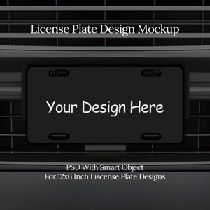 May include: A black license plate mockup with the text "Your Design Here" in white. The plate is 12 inches by 6 inches and is designed for use with a Photoshop smart object.