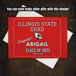 May include: Red and white graduation card with the text "Illinois State Grad" and "Congrats! Abigail Class of 2023 Agriculture".