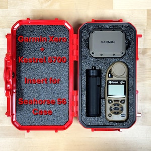 May include: Red carrying case with foam insert for a Garmin Xero Kestrel 5700. The case is open and shows the foam insert with cutouts for the device, a small black tube, and a Garmin device.