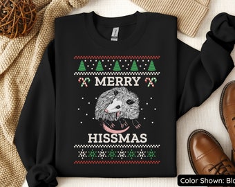 May include: Black Christmas sweater with a white opossum and the text "Merry Hisssmas".
