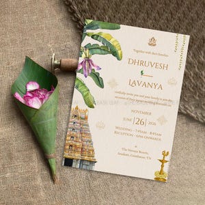 May include: Wedding invitation with floral and architectural illustrations. The invitation features the names Dhrvesh and Lavanya, with the date June 26, 2026. A green leaf cone holds pink flower petals. The invitation is on a beige background.