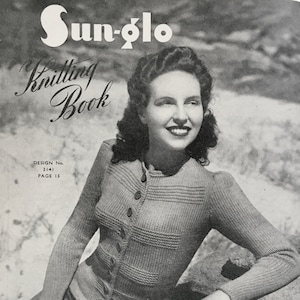 May include: A black and white photograph of a woman wearing a knitted cardigan with buttons. The cardigan has a textured pattern. The photo is from a knitting book called "Sun-Glo Knitting Book" with the design number 3141 and page 15. The book is part of series 83 and costs 7d.